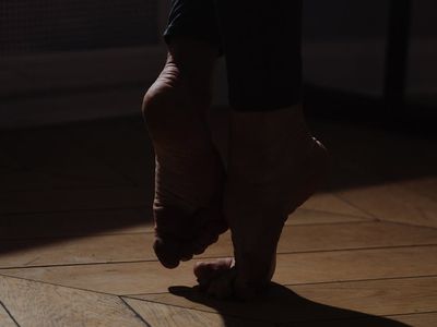 Silhouette of a person performing a balance exercise